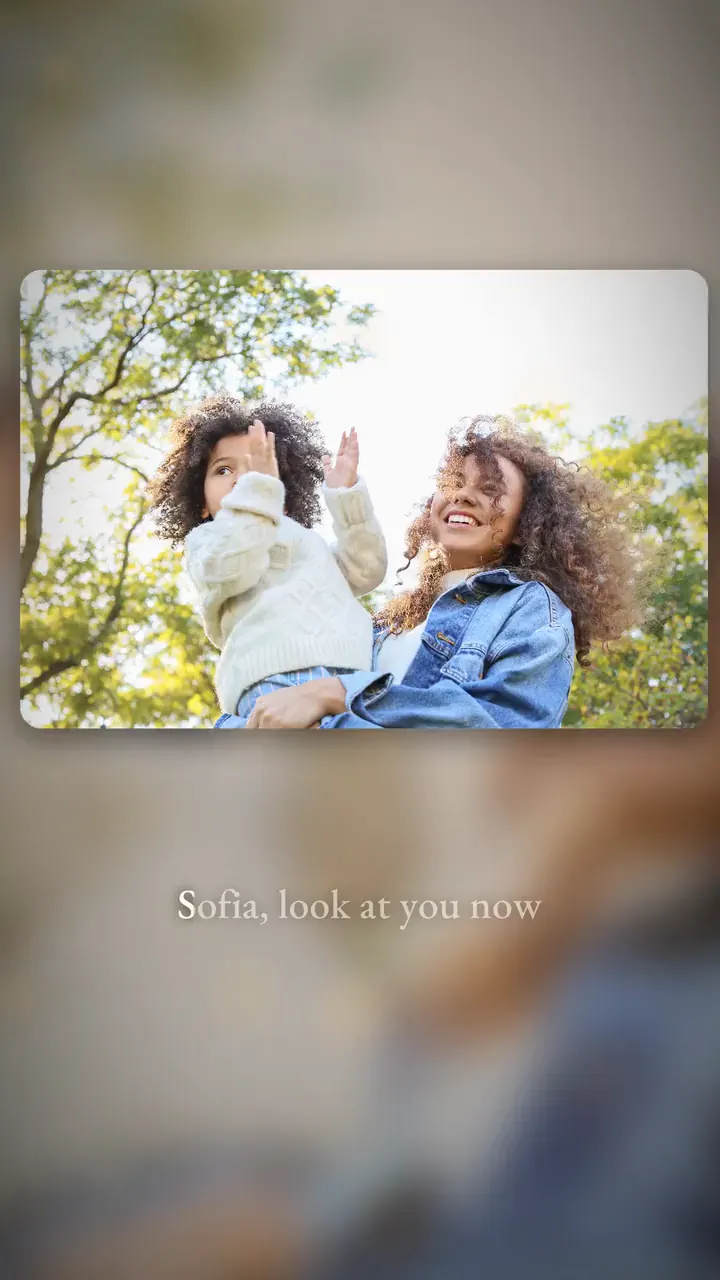 A few seconds of a photo lyric video: a mother and daughter's photos, with the words of her song lighting up as it's sung